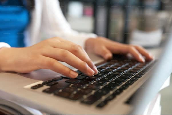 student typing on a keyboard