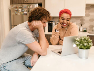 two looking at a laptop