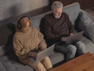 old couple using laptops