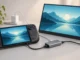 a Steam Deck beside a portable monitor, USB-C hub and charger